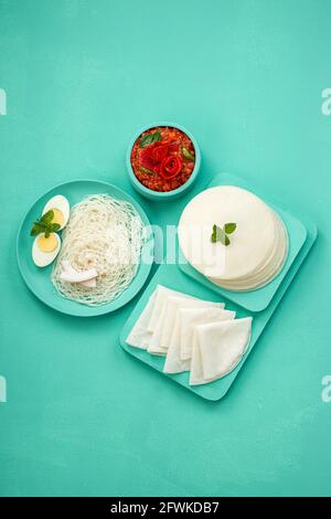 Rice Pathiri and Idiyappam, south indian malabar special breakfast made using rice flour which is white in colour, arranged in a aquamarine colour. Stock Photo