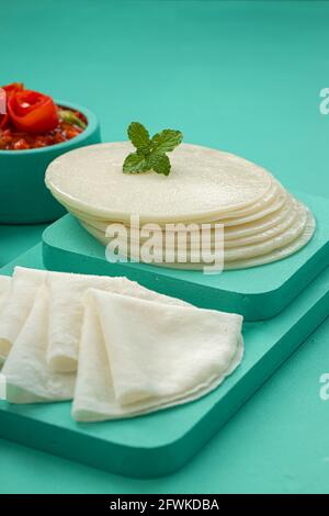 Rice Pathiri and Idiyappam, south indian malabar special breakfast made using rice flour which is white in colour, arranged in a aquamarine colour. Stock Photo