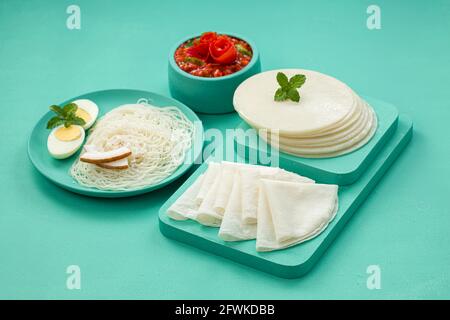 Rice Pathiri and Ideyappam, south indian malabar special breakfast made using rice flour which is white in colour, arranged in a aquamarine solid colo Stock Photo