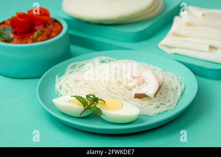 Rice Pathiri and Ideyappam, south indian malabar special breakfast made using rice flour which is white in colour, arranged in a aquamarine solid colo Stock Photo