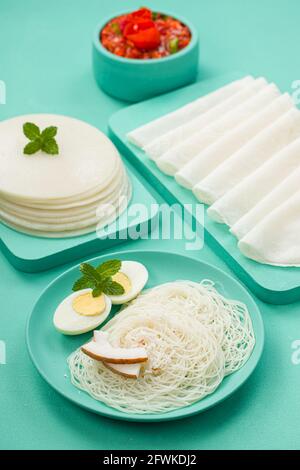 Rice Pathiri and Ideyappam, south indian malabar special breakfast made using rice flour which is white in colour, arranged in a aquamarine solid colo Stock Photo