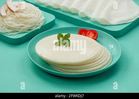 Rice Pathiri and Ideyappam, south indian malabar special breakfast made using rice flour which is white in colour, arranged in a aquamarine solid colo Stock Photo