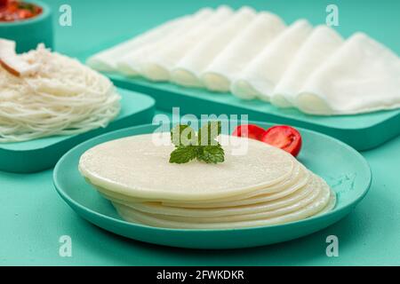 Rice Pathiri and Ideyappam, south indian malabar special breakfast made using rice flour which is white in colour, arranged in a aquamarine solid colo Stock Photo