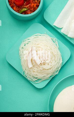 Rice Pathiri and Ideyappam, south indian malabar special breakfast made using rice flour which is white in colour, arranged in a aquamarine solid colo Stock Photo