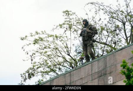 Nuremberg, Germany. 23rd May, 2021. An officer of the police special task force (SEK) monitors the rally 'No to Jew-hatred' from a roof. The rally is supported, among others, by the Alliance against Right-Wing Extremism and the Council of Religions in the Nuremberg Metropolitan Region. Credit: Nicolas Armer/dpa/Alamy Live News Stock Photo