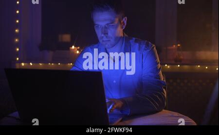 Man working on laptop pc at late night. Stock Photo
