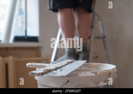 Tub of spackling past with a plastic putty knife. Stock Photo