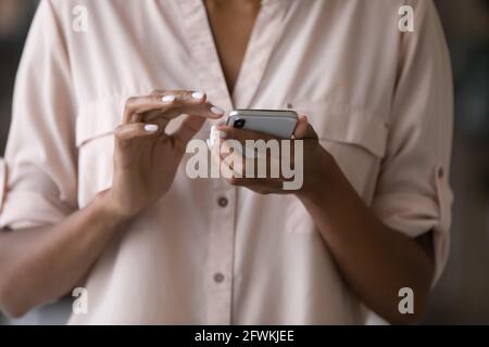 Close up millennial african woman using smartphone. Stock Photo