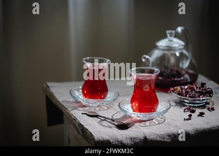 Hot red karkade tea in a glasses on rustic background Stock Photo