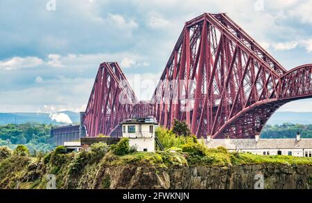 Flying Scotsman steam train crossing the iconic Forth Rail Bridge on its way towards Fife seen from North Queensferry, Scotland, UK