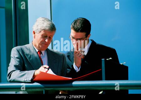 Business executive men standing outside office building. Stock Photo