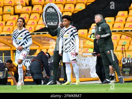 Manchester United's Hannibal Mejbri (left) and Shola Shoretire prepare to come on as substitutes during the Premier League match at the Molineux Stadium, Wolverhampton. Picture date: Sunday May 23, 2021. Stock Photo