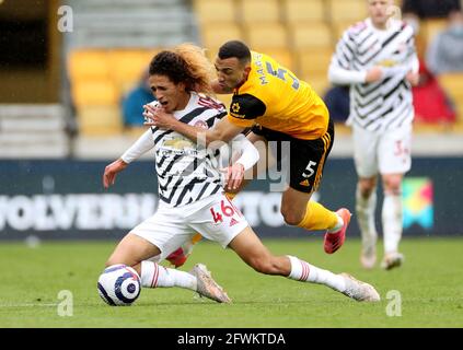 Manchester United's Hannibal Mejbri (left) is tackled by Wolverhampton Wanderers' Marcal during the Premier League match at the Molineux Stadium, Wolverhampton. Picture date: Sunday May 23, 2021. Stock Photo