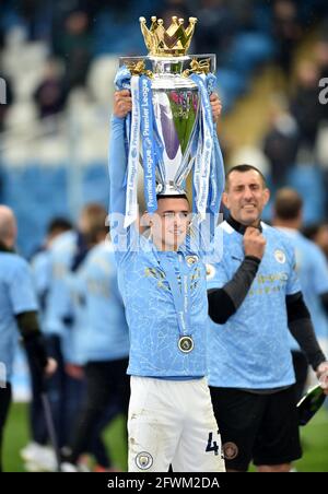 Manchester City's Phil Foden celebrates with the trophy after the Premier League match at the Etihad Stadium, Manchester. Picture date: Sunday May 23, 2021. Stock Photo