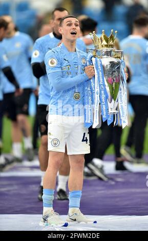 Manchester City's Phil Foden celebrates with the trophy after the Premier League match at the Etihad Stadium, Manchester. Picture date: Sunday May 23, 2021. Stock Photo