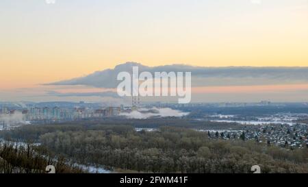 Smoking chimneys over the city. Air pollution Stock Photo