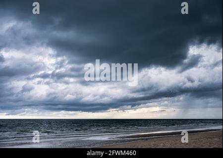 Dark dramatic sky and stormy clouds over tropical sea Stock Photo