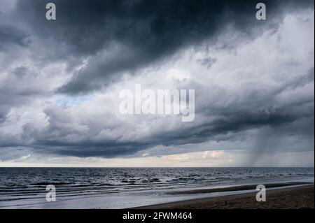 Dark dramatic sky and stormy clouds over tropical sea Stock Photo