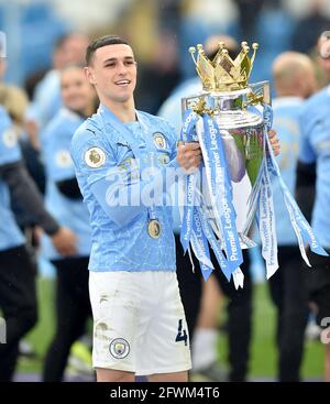 Manchester City's Phil Foden poses with the trophy after the Premier League match at the Etihad Stadium, Manchester. Picture date: Sunday May 23, 2021. Stock Photo