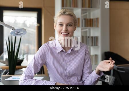 Head shot portrait of smiling businesswoman speaking at camera Stock Photo