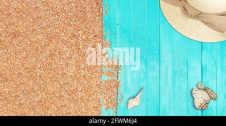Marine banner. Turquoise wooden planks of the pier with pebble beach sand. Hat with seashells. Travel and tourism. Summer background. Copy space Stock Photo