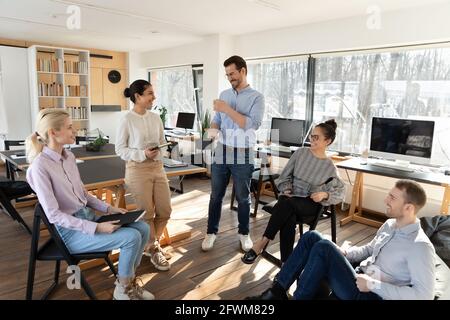 Happy diverse colleagues employees team having fun at meeting Stock Photo