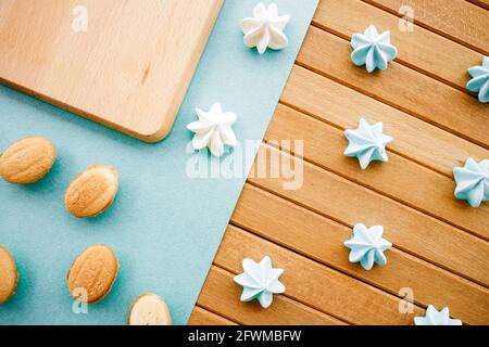Confectionery for coffee on a wooden table. White marshmallows and shortcrust pastry cookies.  Stock Photo