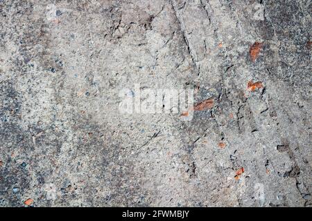 Abstract grunge concrete gray uneven texture. Promotional loose gray wallpaper with space.  Stock Photo