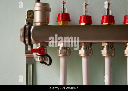 underfloor heating manifold with ventilation opening and piping Stock Photo