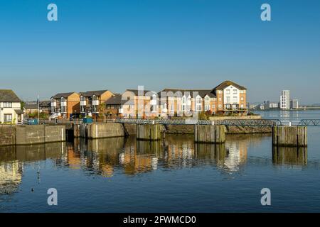 Penarth, Cardiff, Wales - May 2018: Houses on the waterfront of Cardiff bay near the entrance to Penarth marina, in early morning light Stock Photo