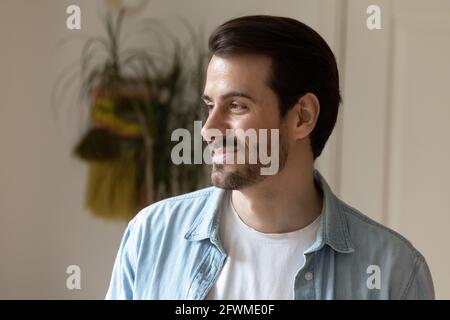 Dreamy young happy man looking in distance. Stock Photo