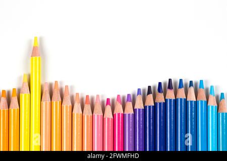 Colored pencils frame on white background. Top view. Learning, art, diversity, creative entertainment concept Stock Photo