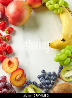 frame of fresh fruit and berries on kitchen table, top view Stock Photo