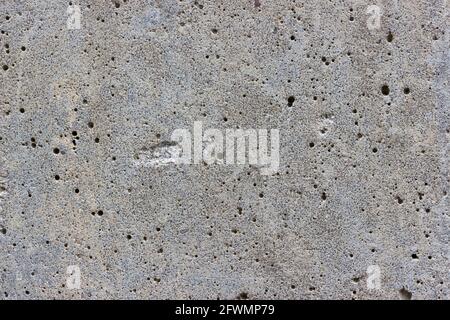 A flat grey concrete textured surface covered in lots of air bubbles Stock Photo