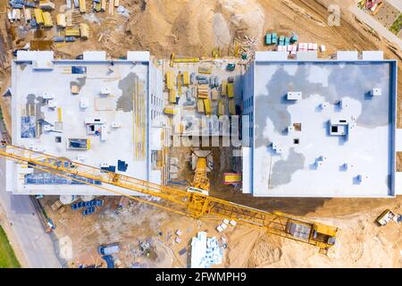 Construction site with cranes. Construction workers are building Stock Photo