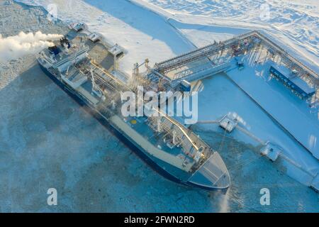 Sabetta, Tyumen region, Russia - March 30, 2021: The Vladimir Vize gas carrier is loaded with liquefied natural gas at the berth.
