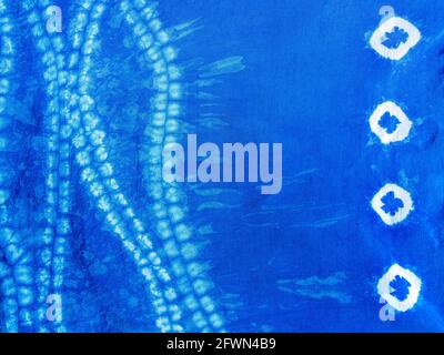 Indigo blue fabric tie dye pattern background. Indigo-Dyed fabric texture with abstract ethnic graphic motif pattern. Stock Photo