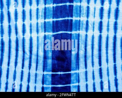 Indigo blue fabric tie dye pattern background. Indigo-Dyed fabric texture with abstract ethnic graphic motif pattern. Stock Photo
