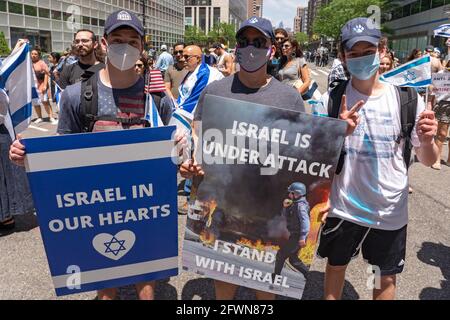 New York, United States. 23rd May, 2021. Pro-Israel supporters hold placards saying Israel In Our Hearts and Israel Is Under Attack I Stand With Israel during a rally.Jewish and pro-Israel demonstrators gathered at the site of the World Trade Center, waving Israeli and American flags in solidarity with Israel following the most recent war with Hamas in Gaza, and in protest against rising levels of antisemitism and severe anti-Jewish attacks in the wake of the conflict. (Photo by Ron Adar/SOPA Images/Sipa USA) Credit: Sipa USA/Alamy Live News Stock Photo