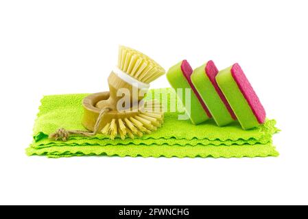 Multicolored cleaning sponges and dish brushes on microfiber cloth isolated on a white background. House cleaning products Stock Photo