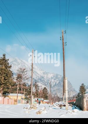 Village at the foot of the mountains in winter, wild life, winter background Stock Photo