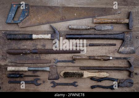 Collection of antique woodworking handtools on a rough workbench old wooden Stock Photo