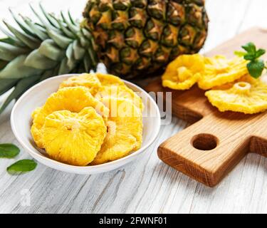 Pineapple dried rings on rustic wooden background Stock Photo
