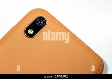 Closeup of Camera module on smartphone brown.Mobile Phone Camera, flash lens. closeup.White background. Stock Photo