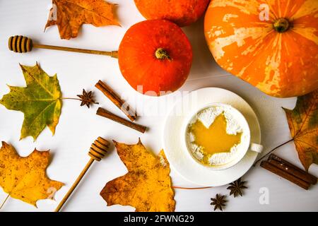 Pumpkin smoothie, spice latte. Boozy cocktail with cinnamon sticks anise stars. Maple leaves decorations. Autumn seasonal hot drinks. Thanksgiving day Stock Photo