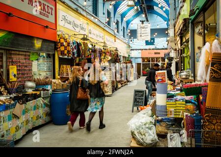 Brixton, London- May 2021: Inside Brixton Village which is part of Brixton Market- an indoor hall of world food stalls, bars and shops. Stock Photo