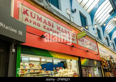 Brixton, London- May 2021: Inside Brixton Village which is part of Brixton Market- an indoor hall of world food stalls, bars and shops. Stock Photo