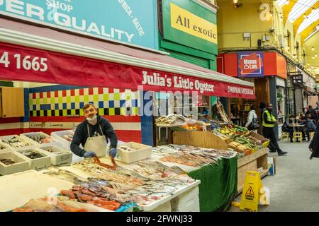 Brixton, London- May 2021: Inside Brixton Village which is part of Brixton Market- an indoor hall of world food stalls, bars and shops. Stock Photo