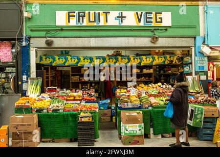 Brixton, London- May 2021: Inside Brixton Village which is part of Brixton Market- an indoor hall of world food stalls, bars and shops. Stock Photo