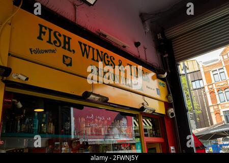 Brixton, London- May 2021: Inside Brixton Village which is part of Brixton Market- an indoor hall of world food stalls, bars and shops. Stock Photo